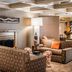 The Woodlands Inn in Wilkes-Barre lounge with patterned sofas, fireplace, and floor lamp