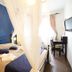 Hotel Noto Marina Vista Mare room in Noto with canopy bed, blue accent wall and desk