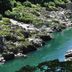 Hotel Obokekyo Mannaka in Miyoshi overlooking a turquoise river between rocky, forested cliffs.