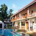Haus Berlin Bentota outdoor pool beside two-story guesthouse with balconies and palm trees