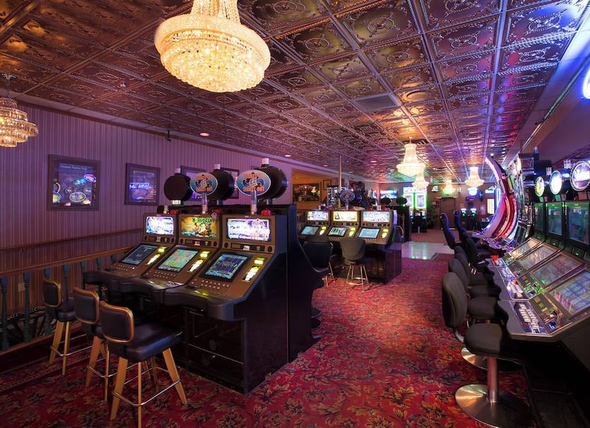 Prospector Hotel & Gambling Hall in Ely casino floor with slot machines and ornate chandeliers