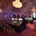 Prospector Hotel & Gambling Hall in Ely casino floor with slot machines and ornate chandeliers