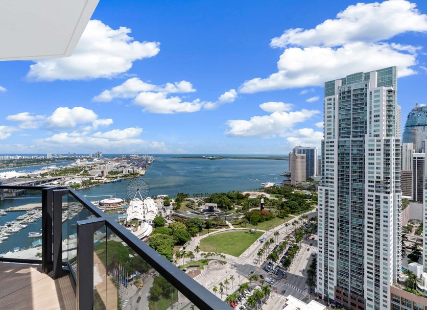 The Elser Hotel Miami balcony view of Miami skyline, marina and bay under a blue sky