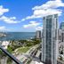 The Elser Hotel Miami balcony view of Miami skyline, marina and bay under a blue sky