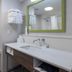 Hampton Inn Dade City - Zephyrhills bathroom with vanity, mirror, toilet and shower