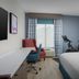 Hilton Garden Inn Abilene guest room with king bed, desk, chair, and exercise bike by the window