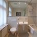Galerie Hotel Leipziger Hof bathroom in Leipzig with tub, wall-mounted sink, toilet and large mirror