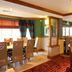 Premier Inn Rugeley dining area with tables, chairs, and warm wood trim