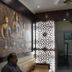 Hotel Ajay International in Agra lobby with Buddha wall art and decorative screen
