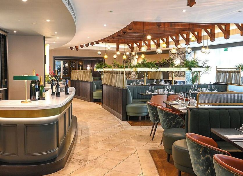 Fota Island Hotel and Spa in Cork: stylish hotel restaurant with curved bar, booths and hanging lights