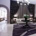 Apollo Hotel Johannesburg lobby lounge with chandelier, purple rug, sofas and floral arrangements