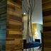 Movich Casa del Alferez in Cali: modern entry with wood walls and tall black sculptural stand