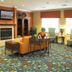 Residence Inn by Marriott Shreveport Airport lobby with fireplace, seating area, and colorful carpet