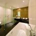 Van der Valk Hotel Harderwijk bathroom with soaking tub, glass shower, vanity and toilet