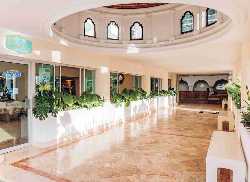 Hotel Solamar Inn in Mazatlán lobby with marble floor, arched ceiling and plants