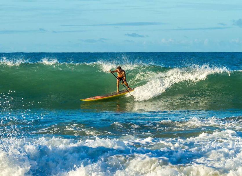 The Inn at Manzanillo Bay in Ixtapa, surfer riding a wave on the ocean