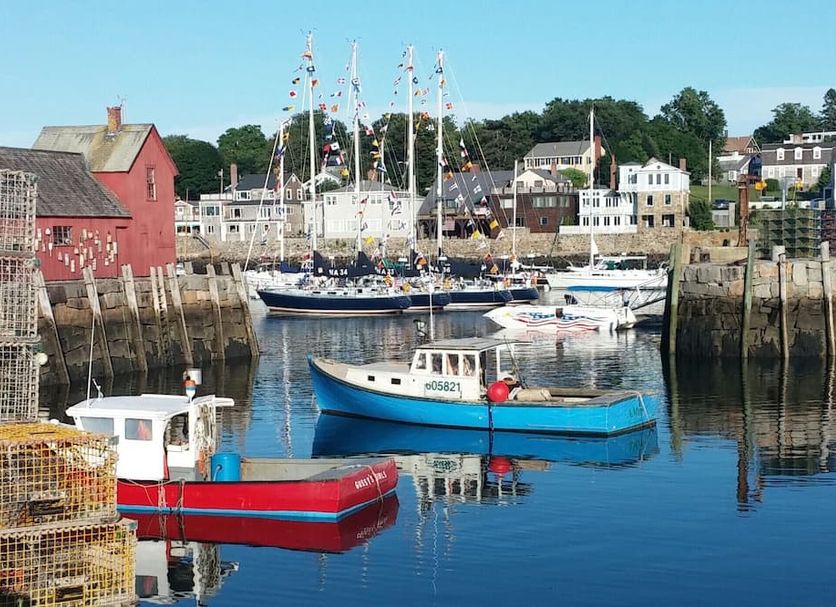 Beach & King Street Inn in Rockport with harbor boats and sailboats on calm water