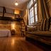 Che Juan Hostel Ba in Buenos Aires with bunk bed, ladder, sofa and warm wooden interior