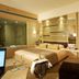 Hengshan Garden Hotel Shanghai guest room with king bed, vanity, glass-enclosed shower, and seating area