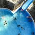 Akay Garden Family Club in Ildir: aerial view of a blue resort pool and waterslide with guests swimming