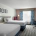 Hilton Garden Inn Tampa-East/Brandon guest room with two beds, desk, and window seat in Tampa