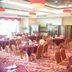 Hubin Bubugao Hotel in Qingyuan banquet hall with round dining tables and red chairs