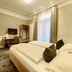 Hotel West an der Bockenheimer Warte room with twin beds, desk, TV and tall window in Frankfurt am Main