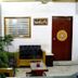 Hotel Ajay International, Agra lobby with seating, potted plants, window, and wooden door