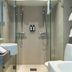 Elite Stadshotellet Växjö bathroom in Vaxjo with glass shower, double sink, and towel rack