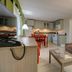 Skaket Beach Motel in Orleans: kitchenette and living area with sofa, TV, dining table and lamp
