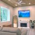 Mar Bella Boutique Hotel & Spa room with TV above fireplace, mirror and sofa in Rehoboth Beach