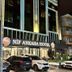 Nif Ankara Hotel entrance in Ankara with lit facade and parked cars at night