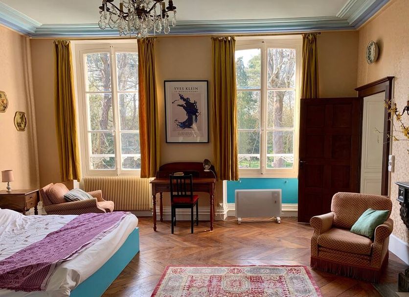 YXIE - manoir des arts guest room in Villeblevin with tall windows, desk, bed and fireplace
