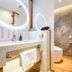 Shanshui Trends Hotel Shao Yao Ju Beijing bathroom with stone vanity, round mirror and glass shower
