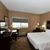 Cobblestone Inn & Suites - Denison guest room with king bed, desk, armchair and window