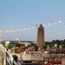 Hyatt Place Augusta rooftop terrace with string lights, seating, and city view at dusk