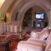 Adanos Konuk Evi in Avanos: cave-style lounge with arched ceiling, patterned sofas, and TV