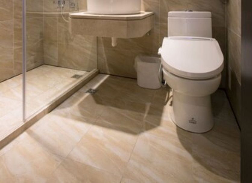 Noble Hotel Taipei City bathroom with glass shower, sink, and toilet