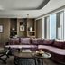 Rosewood Guangzhou in Guangzhou living room with curved sofa and floor-to-ceiling city views