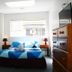 Backpackers Central Hamilton room with double bed, bedside lamps, sofa and dresser in Hamilton