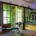 Baumanière - Les Baux de Provence fitness room with treadmill, exercise bike and open garden doors in Les Baux-de-Provence
