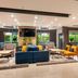 Courtyard by Marriott San Salvador lobby with blue sofa, lounge chairs, large windows and colorful wall panels