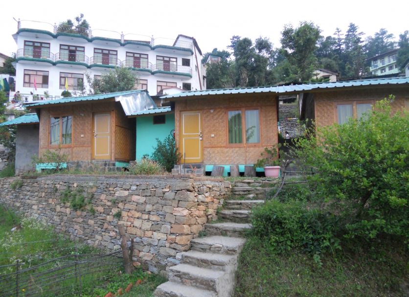Hotel Sumit Kausani in Kausani with hillside cottages and stone steps leading up the slope