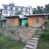 Hotel Sumit Kausani in Kausani with hillside cottages and stone steps leading up the slope