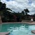 Cabinas La Catarata in La Fortuna pool with tropical garden and cloudy sky