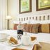 Kingfisher Guesthouse Port Elizabeth bedroom tray with coffee, tea, and pastries on a bed
