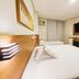 Hotel Itamarati Centro-República in Sao Paulo: compact twin room with two beds, TV, desk and air conditioner