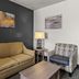 Best Western Sherwood Inn & Suites in North Little Rock guest seating area with sofa, armchair, lamps, and coffee table