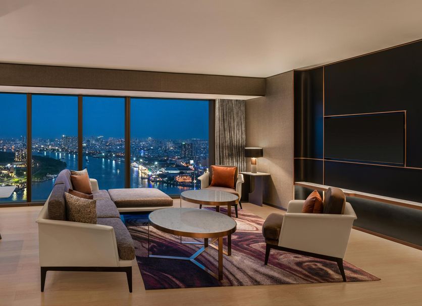Hilton Saigon suite with panoramic Ho Chi Minh City skyline view and modern seating area