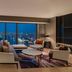 Hilton Saigon suite with panoramic Ho Chi Minh City skyline view and modern seating area